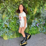 Young girl smiling and posing while wearing black and gold Fit Boots Rebound Boots