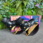 Pair of black and gold Fit Boots Rebound Boots placed in front of a colorful box