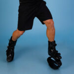 Person standing in a dynamic pose while wearing Fit Boots Rebound Boots